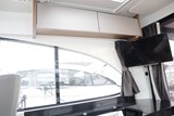 Beneteau Antares 11 OB - galley storage and TV.